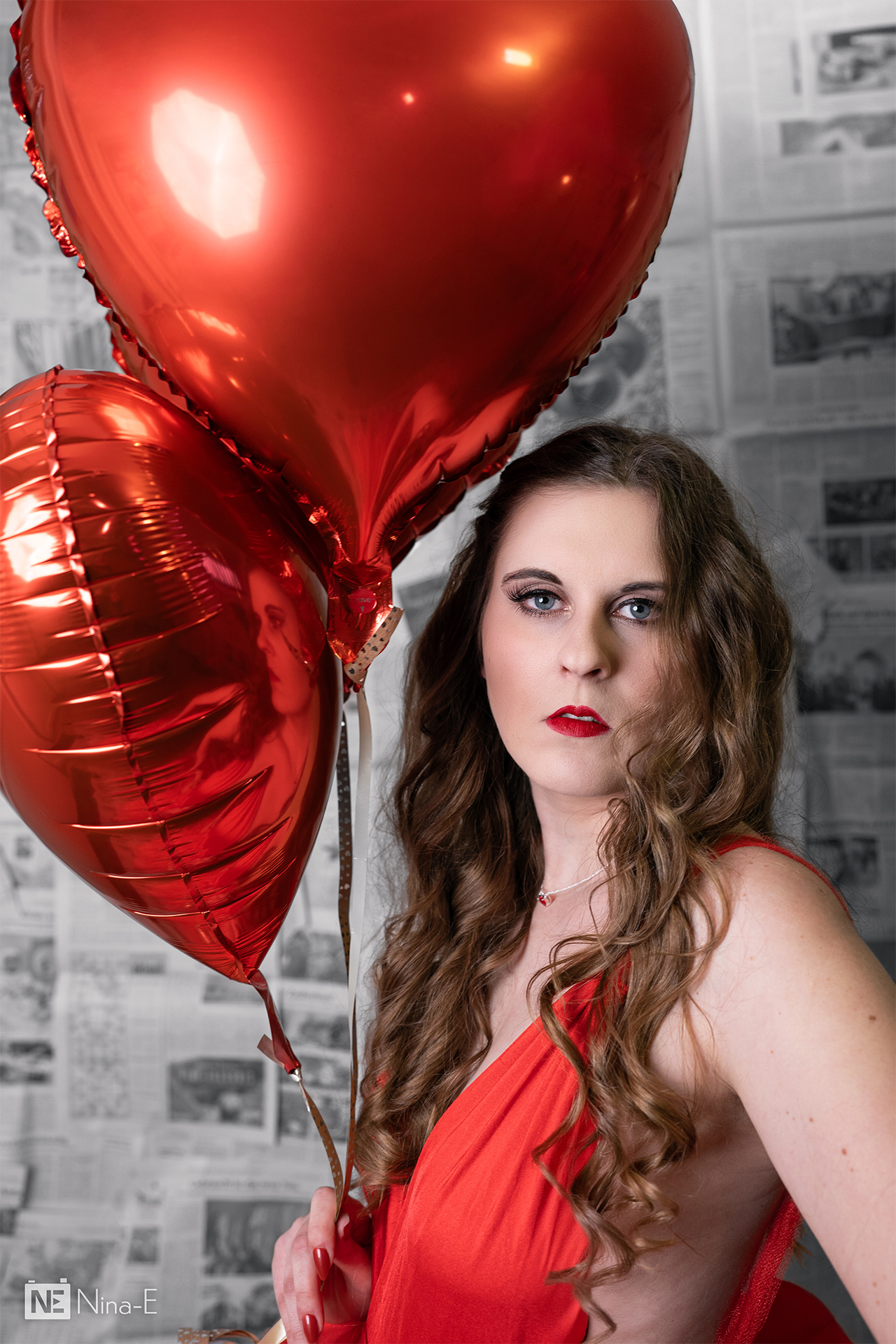 Frau vor Zeitungshintergrund in rotem Kleid